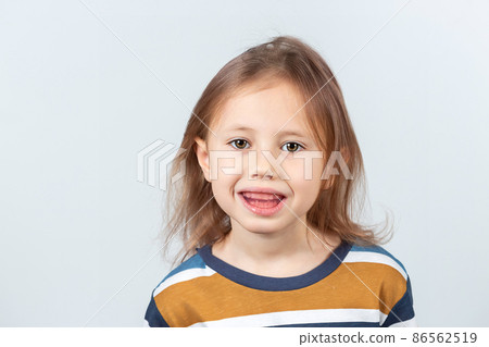 Little girl shows myofunctional trainer. dental tariner is made to correct bite 86562519