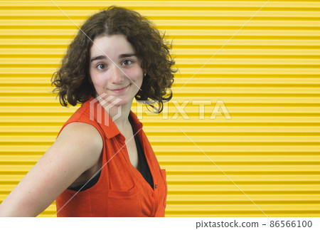 fresh young girl brunette wearing orange on yellow stripe background 86566100