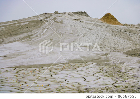 Landscape portrait from Mud Volcanoes - Buzau, Romania. Unique geological phenomenon in Europe where the earth gas reaches the surface through hills making small Mud volcanoes. Out of focus. Landscape portrait from Mud Volcanoes - Buzau, Romania. Unique geological phenomenon in Europe where the earth gas reaches the surface through hills making small Mud volcanoes. Out of focus. 86567553
