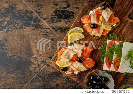 Smorrebrod - traditional Danish sandwiches. Black rye bread with salmon Smorrebrod - traditional Danish sandwiches. Black rye bread with salmon 86567932