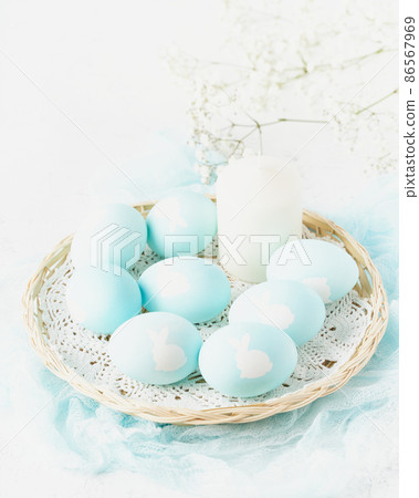 Easter. Holiday. Light white background, gentle pastel colors. Flowers in background, side view Easter. Holiday. Light white background, gentle pastel colors. Flowers in background, side view 86567969