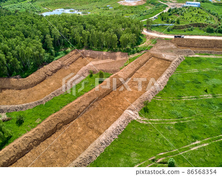Overburden removal during sand pit preparation, aerial view Overburden removal during sand pit preparation, aerial view 86568354
