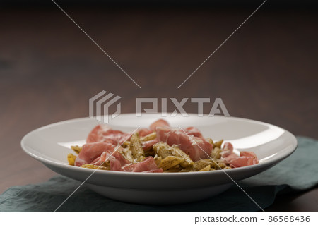 Penne pasta with capocollo, pesto and parmesan cheese 86568436