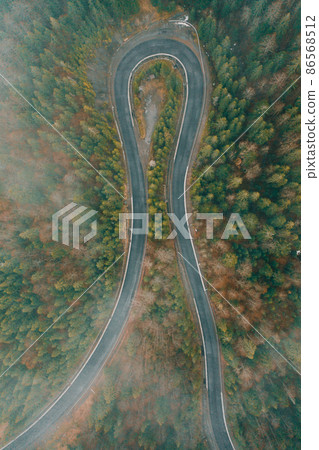 Serpentine roads in Ukraine, fog in the mountains, serpentine road in the fog, drove on top of the road. 86568512