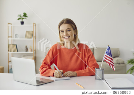 Student at desk studying free online American university academic course during global Covid 19 pandemic, writing essay, scholarship application, preparing for youth job, work travel, USA immigration 86568993