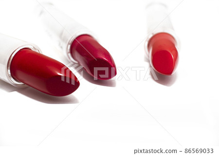 Samples of red lipsticks on a white background. Texture of cosmetic products Samples of red lipsticks on a white background. Texture of cosmetic products 86569033