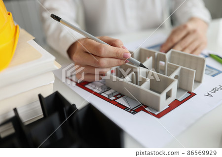 Hands an architect with pencil over the project of a house, blurry Hands an architect with pencil over the project of a house, blurry 86569929