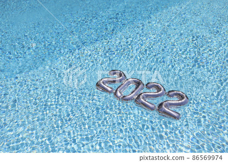 Silver inflatable figures 2022 on blue transparent water 86569974