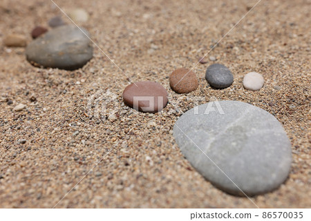 Footprint of stones in the sand, close-up, blurry 86570035