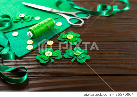 Sewing items for St Patrick decoration on wodden table Sewing items for St Patrick decoration on wodden table 86570064