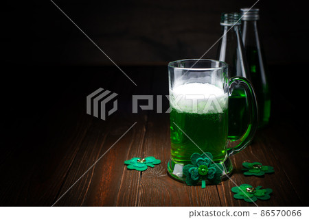 Green beer pint for Saint Patrick day on wooden table Green beer pint for Saint Patrick day on wooden table 86570066