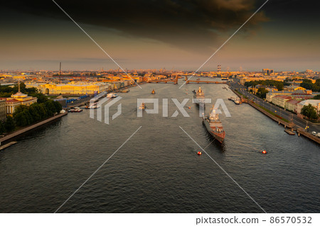 Aerial landscape with warships in the Neva River before the holiday of the Russian Navy at early morning, warships pass under a raised drawbridge, the latest cruisers among landmarks, Palace bridge 86570532