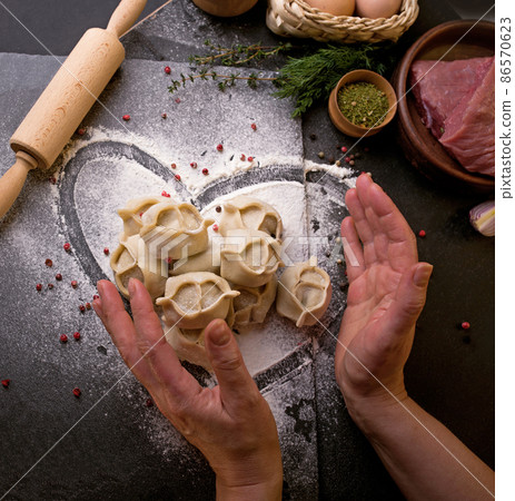 traditional Eastern dish manti or manty with beef in a dark traditional Eastern dish manti or manty with beef in a dark 86570623