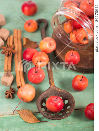 paradise apples, on the wooden table in the rustic style, iron mug. paradise apples, on the wooden table in the rustic style, iron mug. 86570652