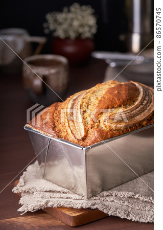 Banana bread in loaf pan. Cake with banana, traditional american cuisine. Whole loaf. 86570745