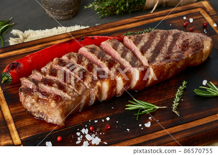 Keto ketogenic diet medium beef steak, grilled striploin on cutting board. Paleo food Keto ketogenic diet medium beef steak, grilled striploin on cutting board. Paleo food 86570755