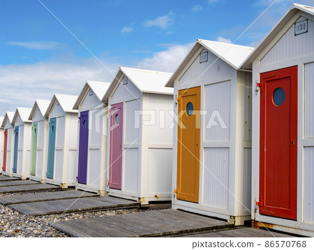 Row of traditional bathing huts with pastel colored doors at Le Treport beach, Normandy, France 86570768