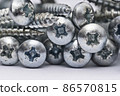 Close up of a pile of multipurpose metal screw heads 86570815