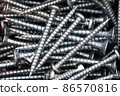 Close up of a pile of multipurpose metal screws 86570816