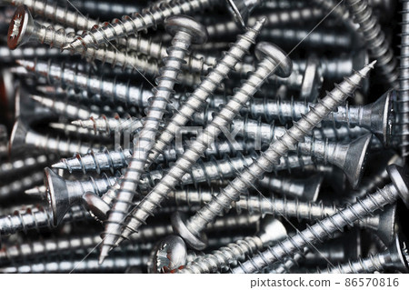 Close up of a pile of multipurpose metal screws Close up of a pile of multipurpose metal screws 86570816