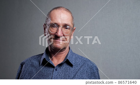 Elderly man with bad eyesight wears elegant glasses smiling Elderly man with bad eyesight wears elegant glasses smiling 86571640