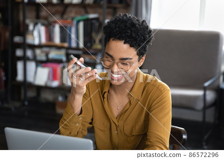 Happy Afro American entrepreneur woman recording audio message Happy Afro American entrepreneur woman recording audio message 86572296