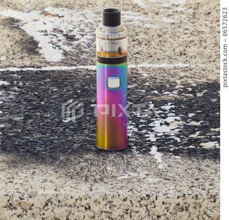 brightly colored vaper, with urban block background brightly colored vaper, with urban block background 86572623