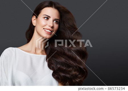 Beautiful brown-haired girl with a perfectly curls hair, and classic make-up. Beauty face and hair. Beautiful brown-haired girl with a perfectly curls hair, and classic make-up. Beauty face and hair. 86573234