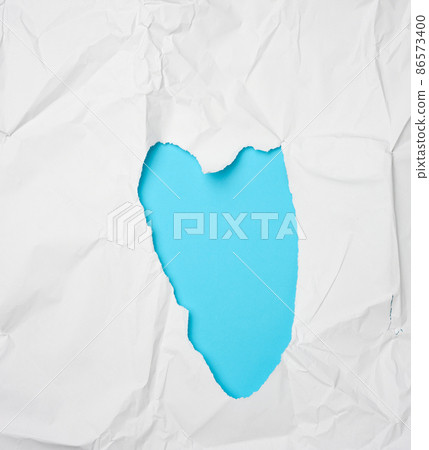 crumpled white paper with a heart-shaped hole 86573400