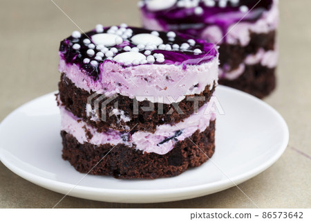 chocolate cake with cream covered with purple berry jam chocolate cake with cream covered with purple berry jam 86573642