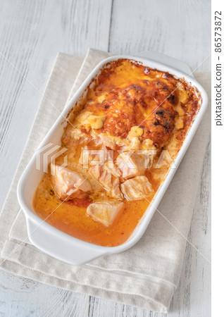 Baked salmon with cheese sauce 86573872
