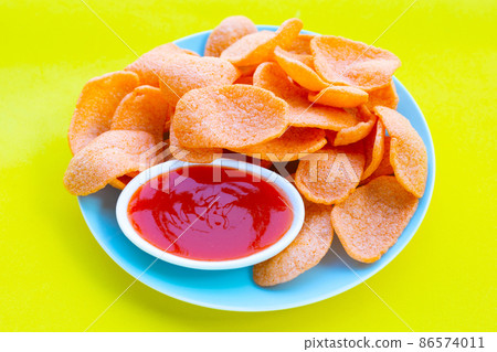 Prawn crackers on green background. Shrimp crispy rice snack 86574011