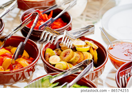 bowls with chopped vegetables and fruits on the table.  86574255