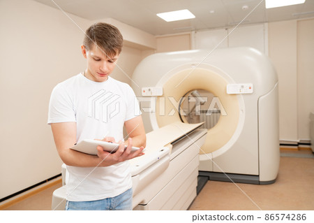 engineer fills after maintenance documents. computer tomograph. engineer fills after maintenance documents. computer tomograph. 86574286