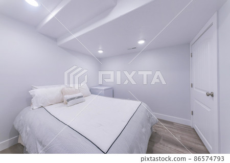 White bedroom interior with wooden flooring and white door 86574793