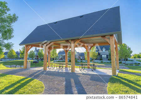 Pavilion with three picnic tables in a public park at Daybreak residential community in Utah Pavilion with three picnic tables in a public park at Daybreak residential community in Utah 86574841