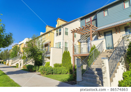 Residential buildings with stairs to the front entrance at Daybreak in South Jordan, Utah 86574863