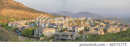 Rows of suburban houses along the curved road at Double Peak Park, San Marcos, California 86575775