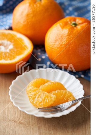 Iyokan peeled and served on a plate Iyokan peeled and served on a plate 86577150