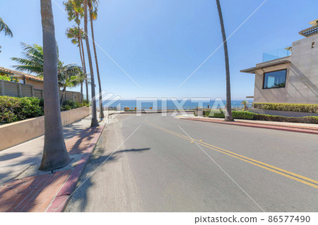Highway with palm trees near the beach at La Jolla in California 86577490