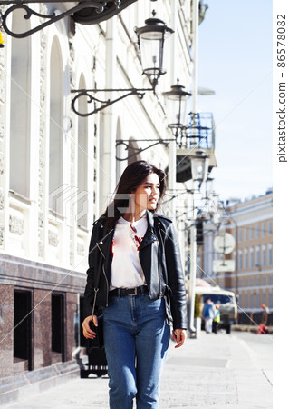 young pretty asian girl wearing leather jacket outside on big city street, lifestyle people concept 86578082