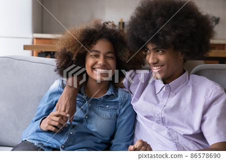 Cheerful happy Black couple of hipster teenagers, students enjoying dating 86578690