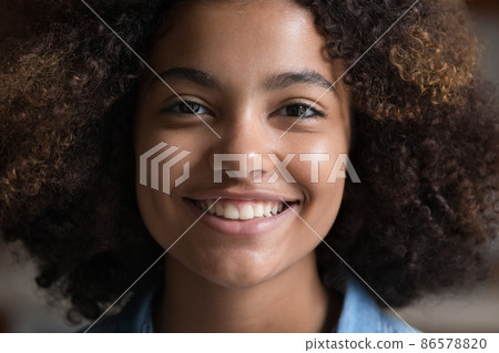 Happy African teenage girl with Afro hairstyle looking at camera Happy African teenage girl with Afro hairstyle looking at camera 86578820