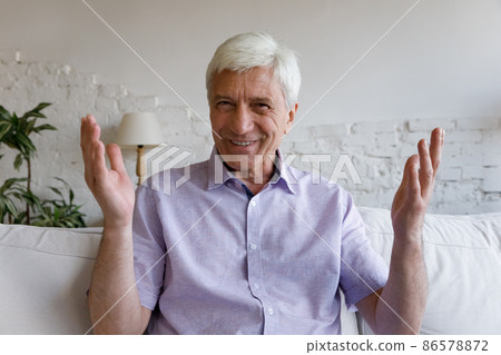 Happy man talking and smiling at camera on video call 86578872