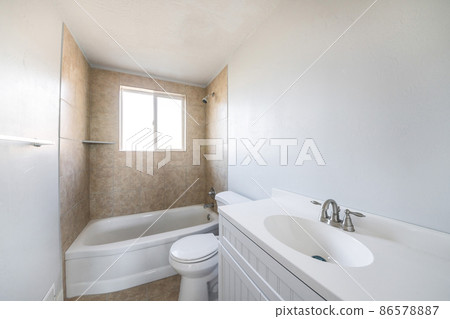 Interior of a bathroom with window on top of a bathtub Interior of a bathroom with window on top of a bathtub 86578887