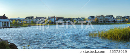 Oquirrh Lake waterfront during sunset at Daybreak, Utah 86578919