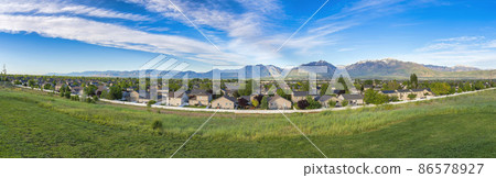 Panoramic view of a residential area with a mountain range background at Daybreak, Utah Panoramic view of a residential area with a mountain range background at Daybreak, Utah 86578927