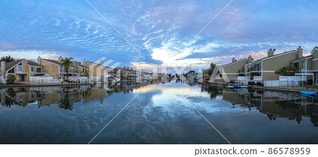 Huntington beach water with a reflection of the sky with sunset hue colors Huntington beach water with a reflection of the sky with sunset hue colors 86578959