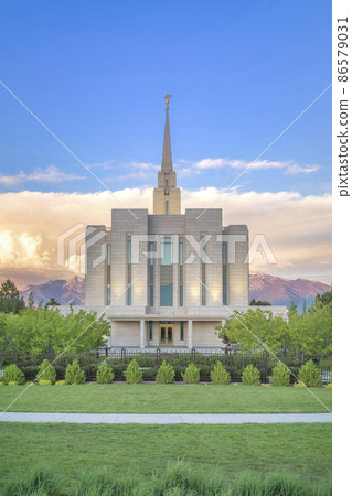 Facade of a fenced LDS church against the mountains and sunset sky at Utah Facade of a fenced LDS church against the mountains and sunset sky at Utah 86579031