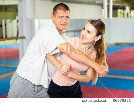 Young woman exercising elbow strike during self-protection training Young woman exercising elbow strike during self-protection training 86579236